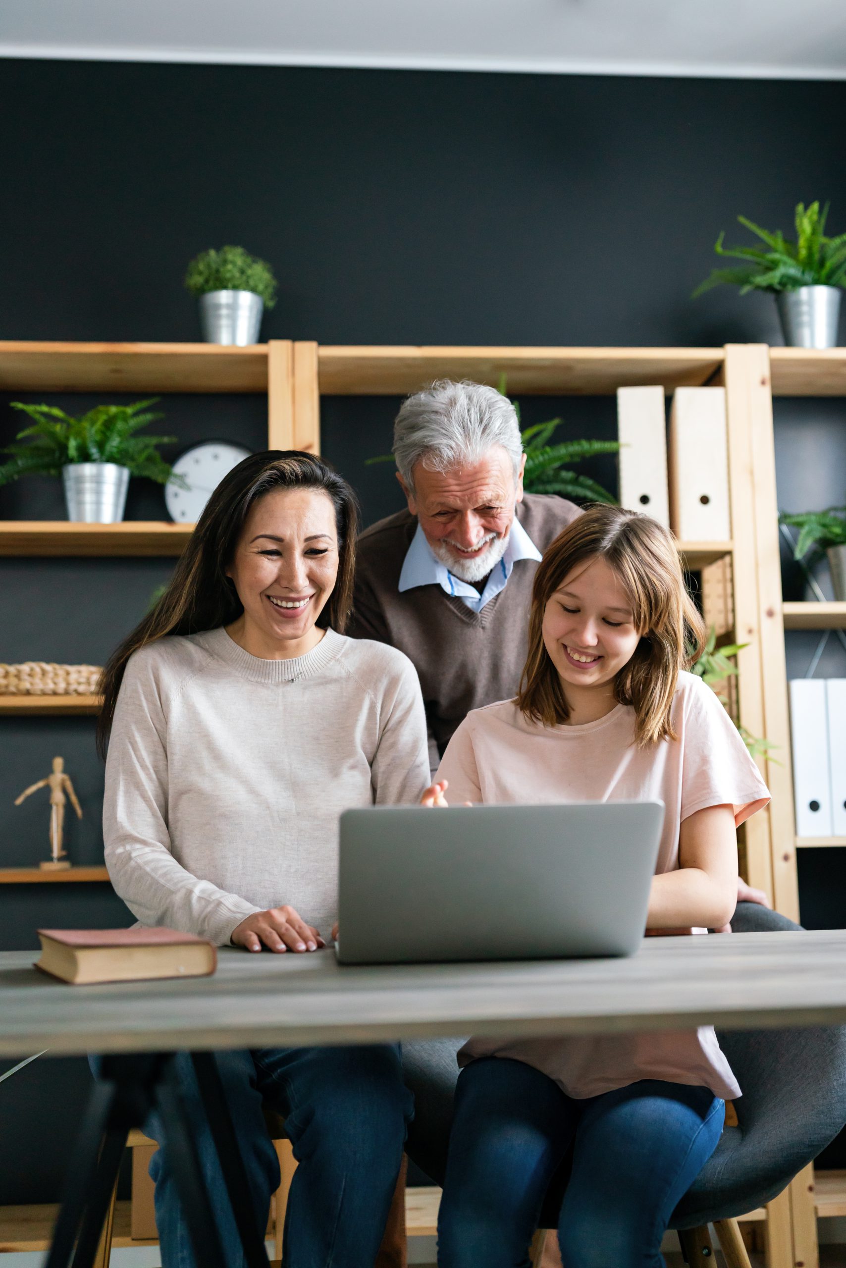 Happy multi generation multiethnic family spend time online with computer together at home,